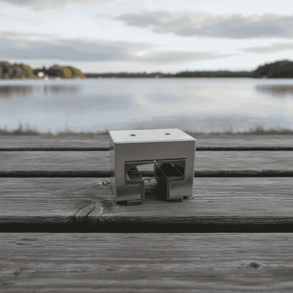 Metal bracket on a wooden surface with a lake and sky in the background